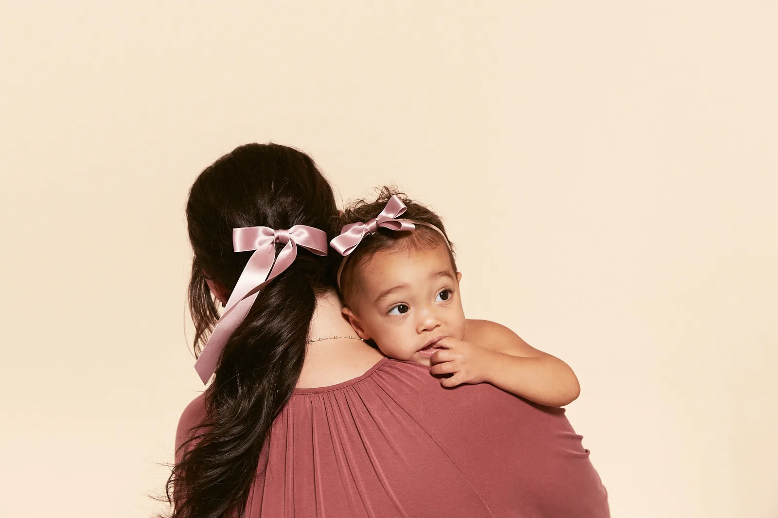 Matching satin bows on a mother and baby