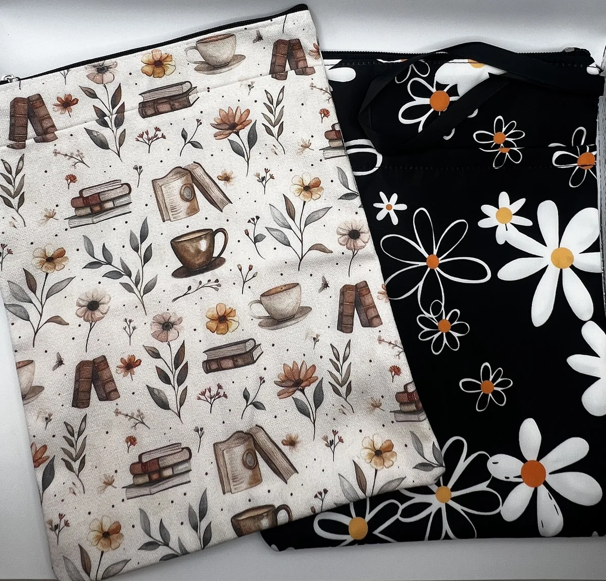 Two padded book sleeves with floral and book prints