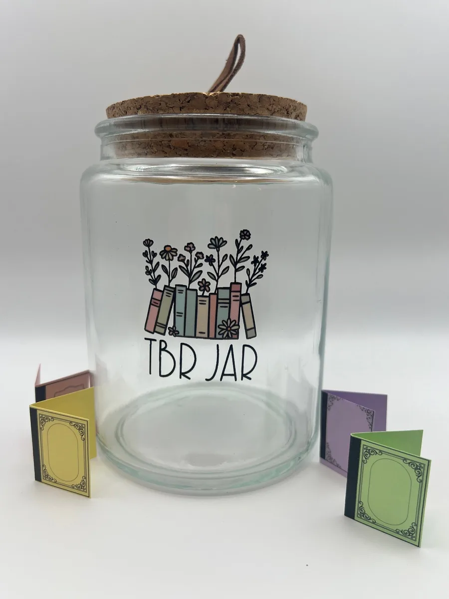 A glass TBR jar with paper book slips