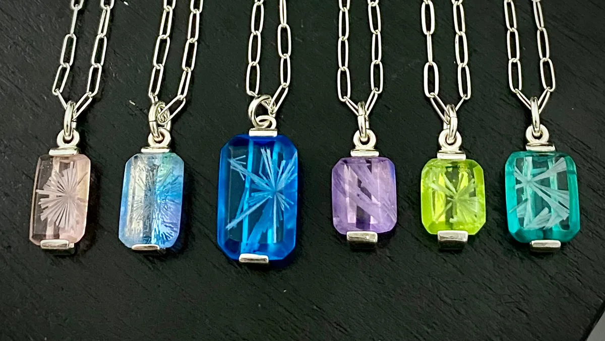 Six Bridewell Stone pendants in pink, aqua, blue, violet, lime and teal on chains