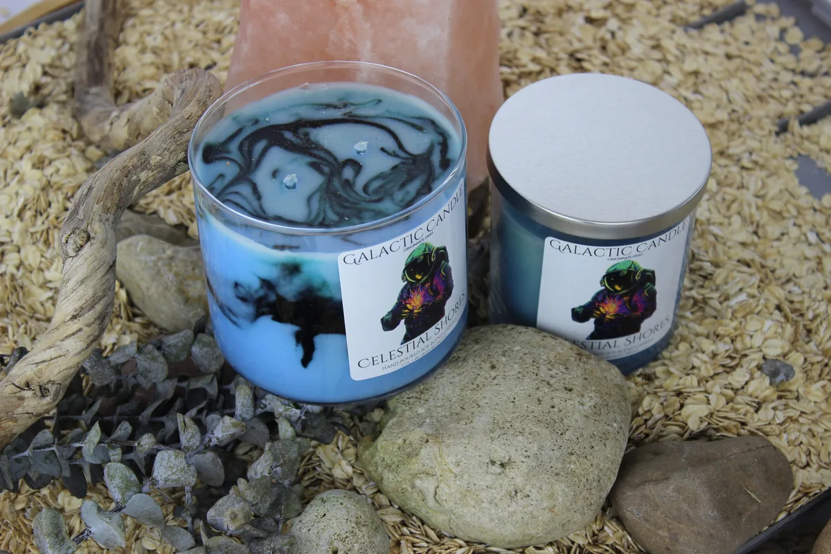 Celestial Shores candles among stones and driftwood