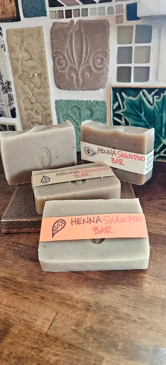 A stack of handmade cold-process soap bars, the Henna Shampoo Bar on top