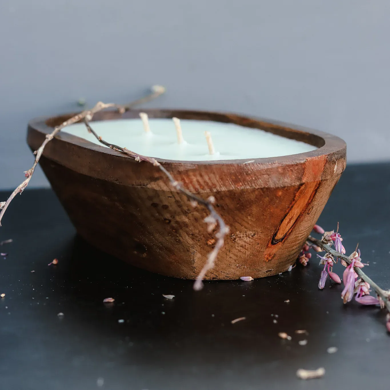 Soy candle poured in a wooden dough bowl