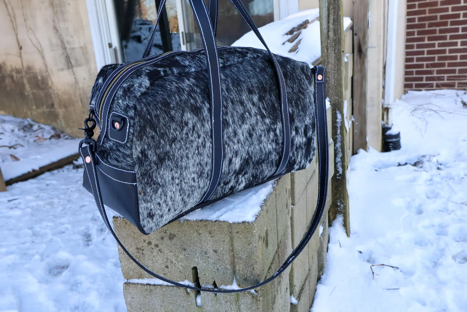 The Ranch Hand, a spotted hair-on-hide duffel bag