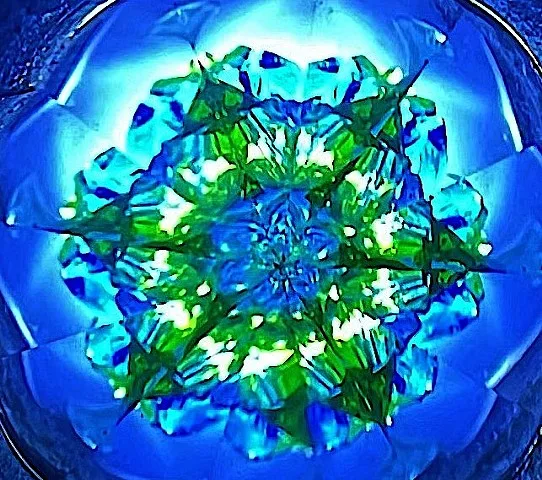 A blue and green pattern seen through a Kosztalascope