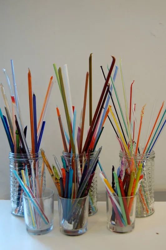 Jars of colored glass rods in her studio