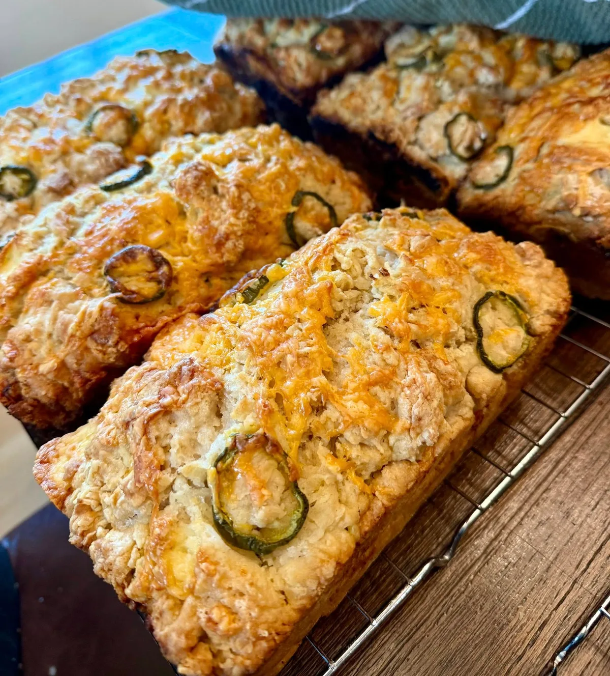 Cheddar jalapeño beer bread loaves cooling on a rack