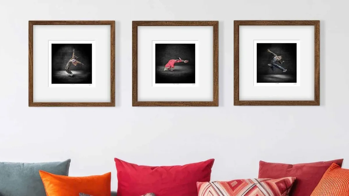 The breakdancing cats framed above a couch