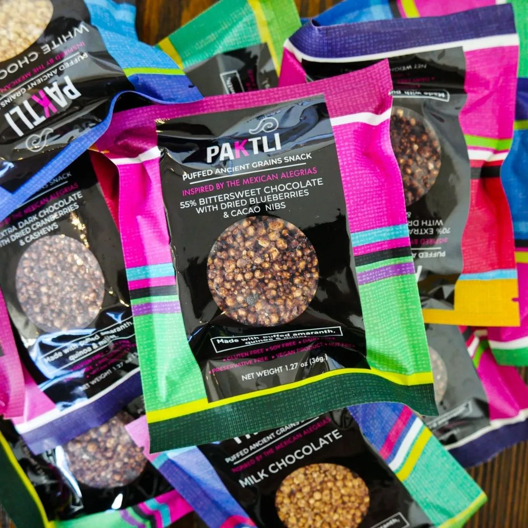 Paktli alegria pouches in their bright woven-pattern packaging