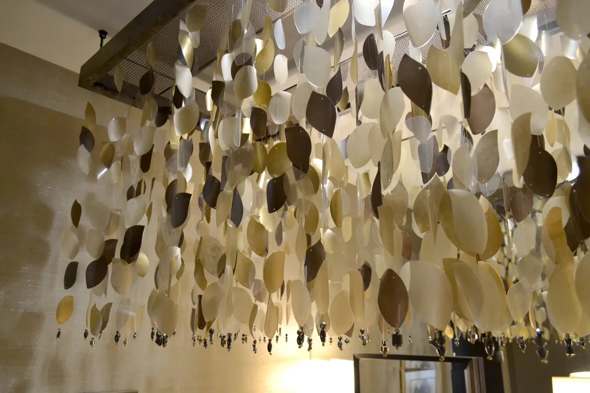 A large installation of metallic paper leaves