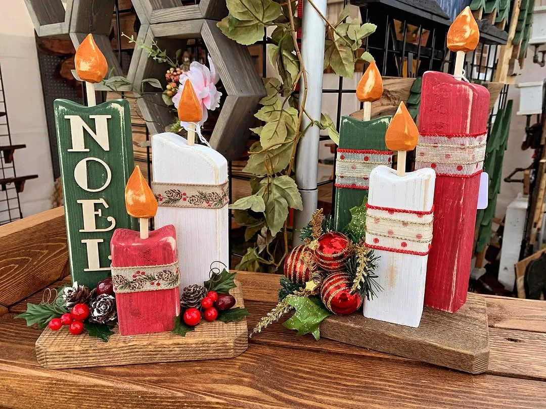 Wooden "Noel" sign and chunky wooden candles with Christmas greenery