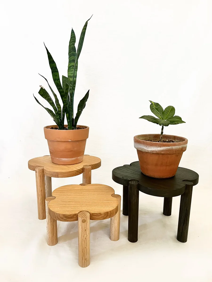 Clover plant stands holding potted plants