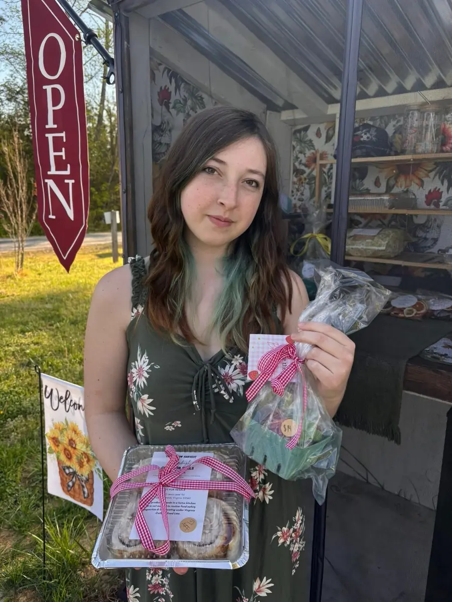 At the stand with a tray of cinnamon rolls, the Open flag flying
