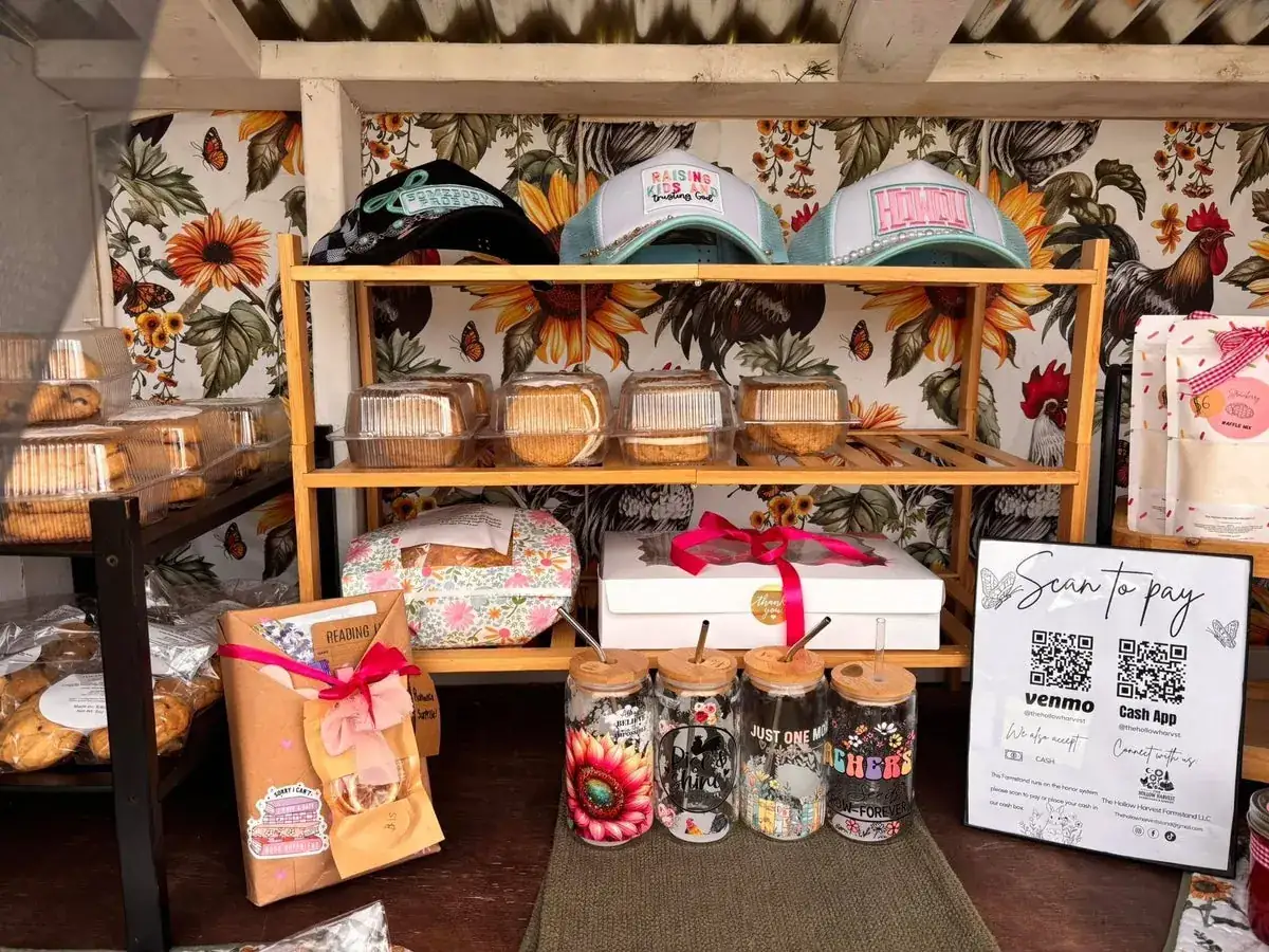 Inside the self-serve stand: shelves of baked goods, jams and the scan-to-pay sign