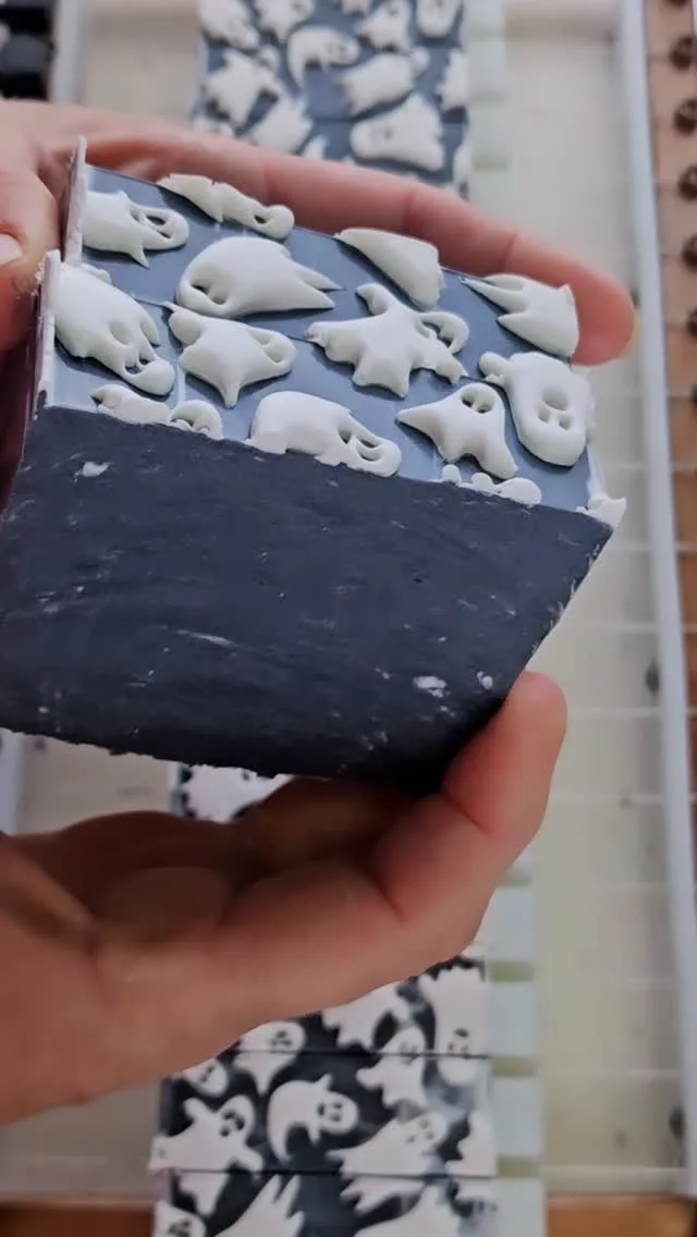 Ghost-stamped Halloween "Boo" soap loaf being cut