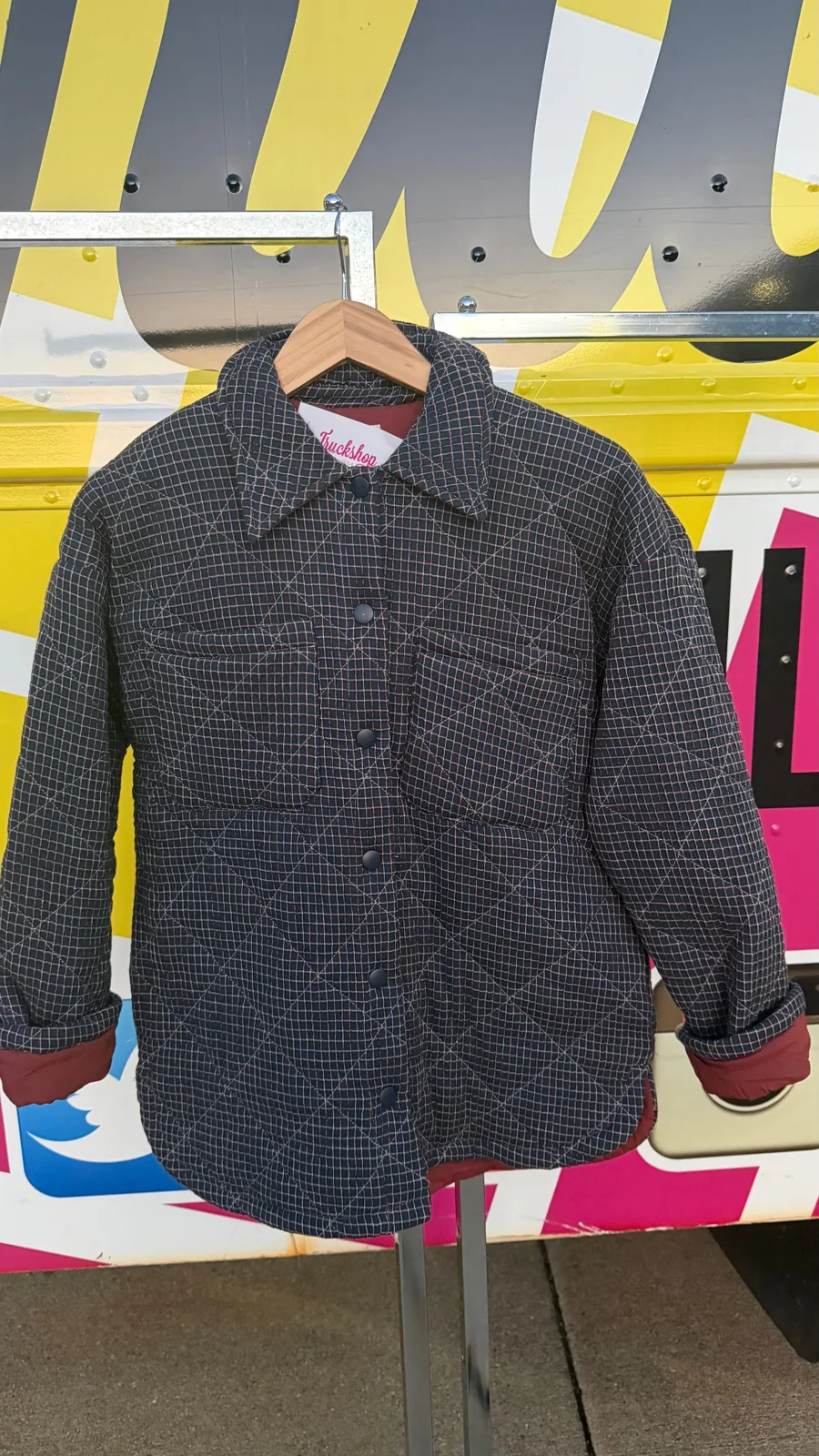 A quilted jacket hanging at the truck