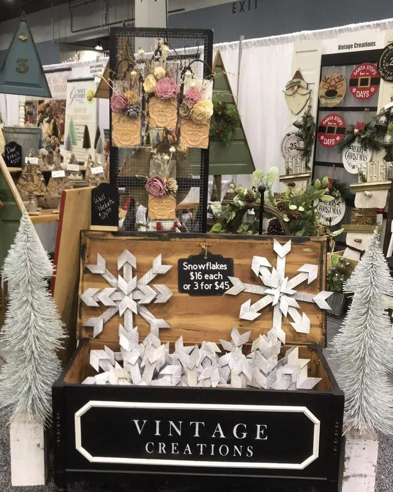 Wooden snowflakes, wreaths and trees at a holiday show